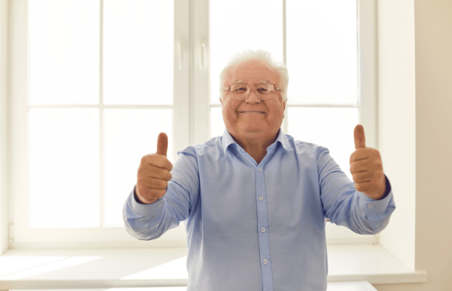 happy senior man giving thumbs up